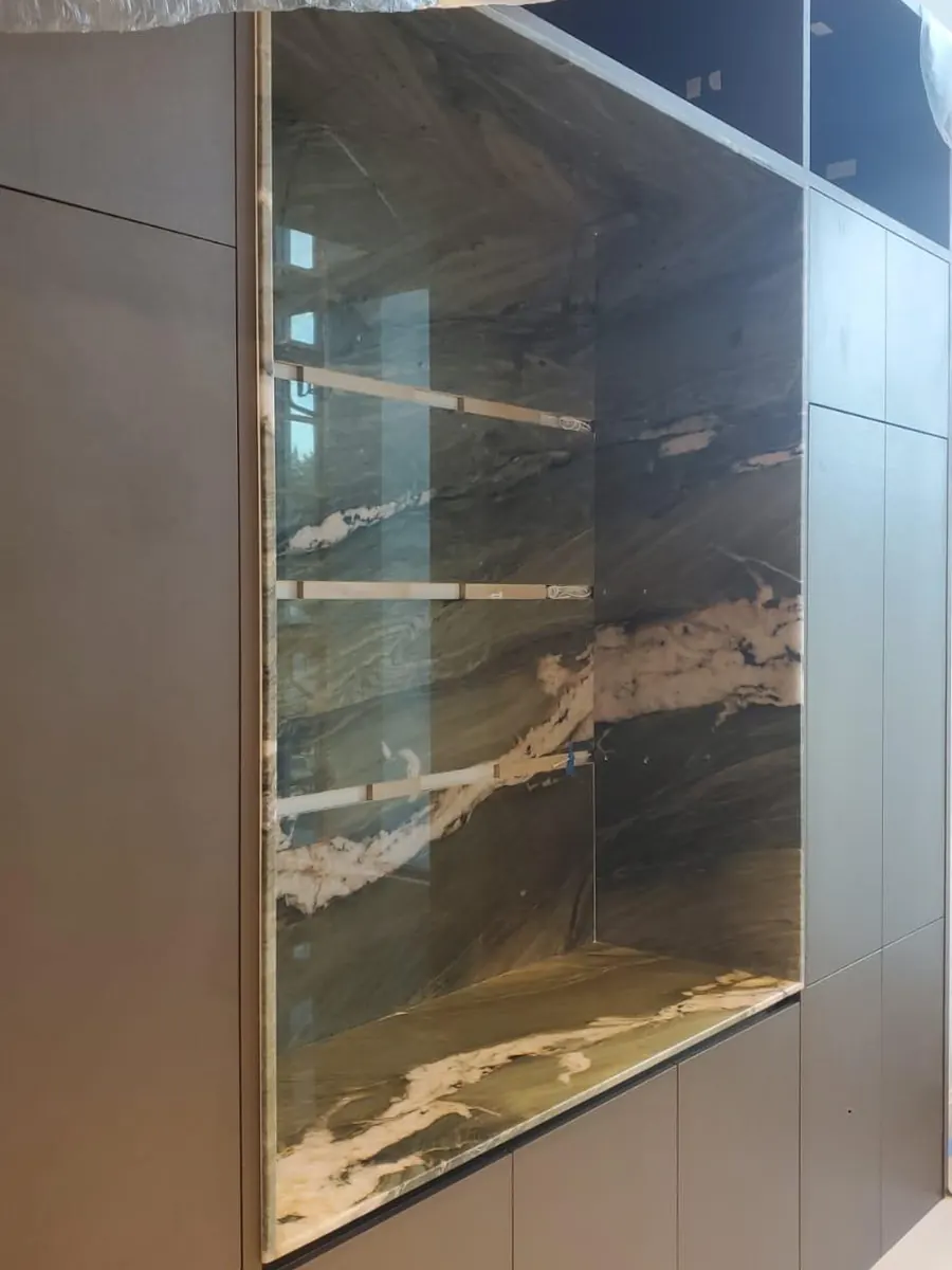 Backlit quartzite panel with floating glass shelves
