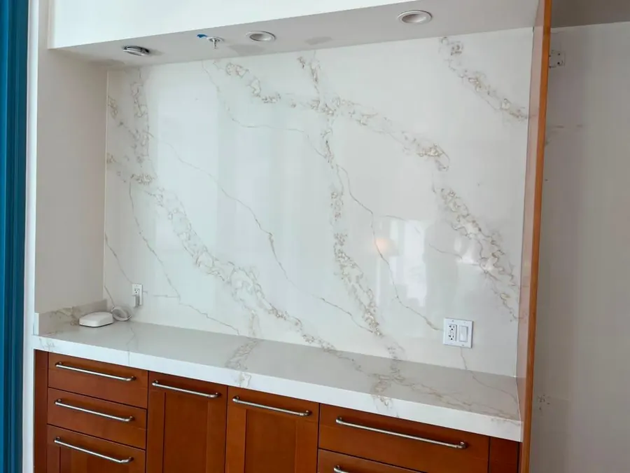 Full-height book-matched backsplash above a kitchen counter