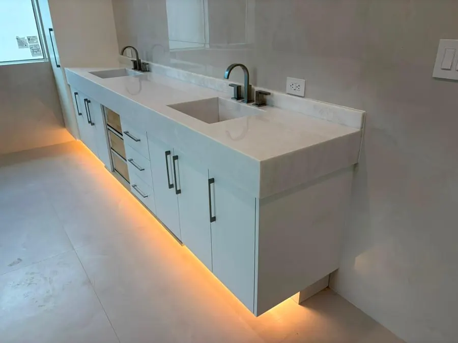 Floating double vanity with sculpted basins and LED underlighting