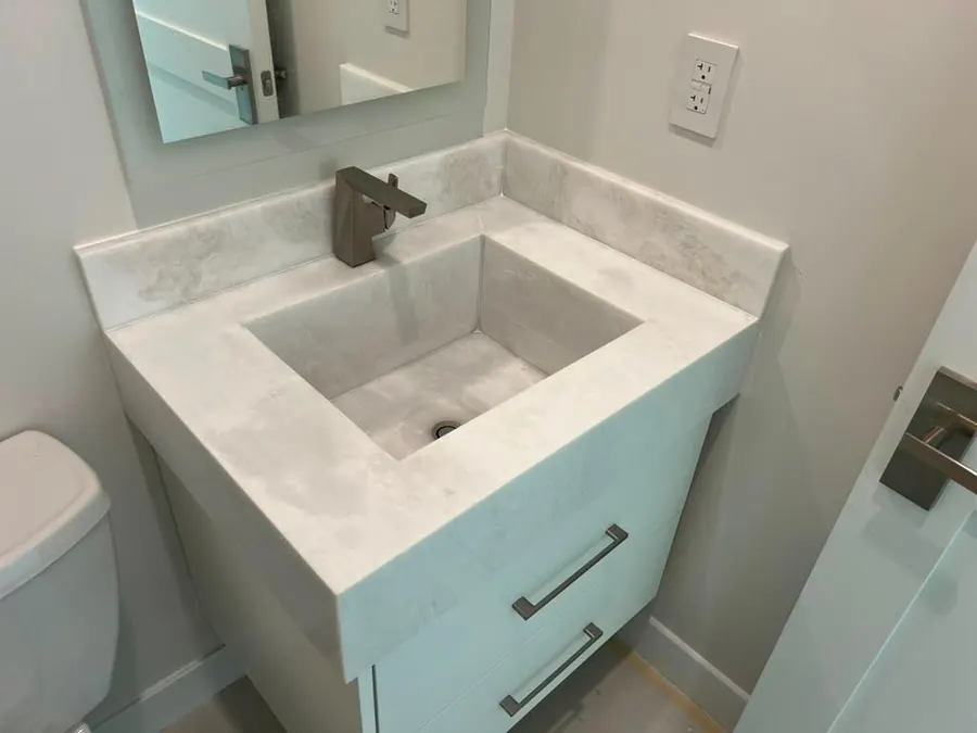 Vanity with a basin sculpted from the same slab as the top
