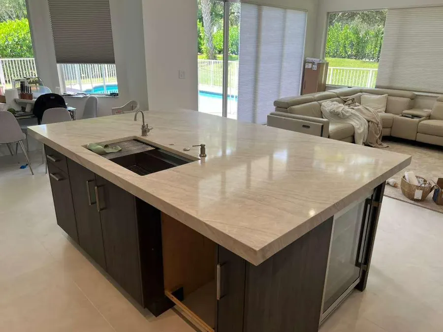Kitchen island with integrated sink opening onto a pool deck