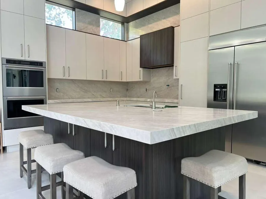 Large kitchen island with waterfall edge and seating