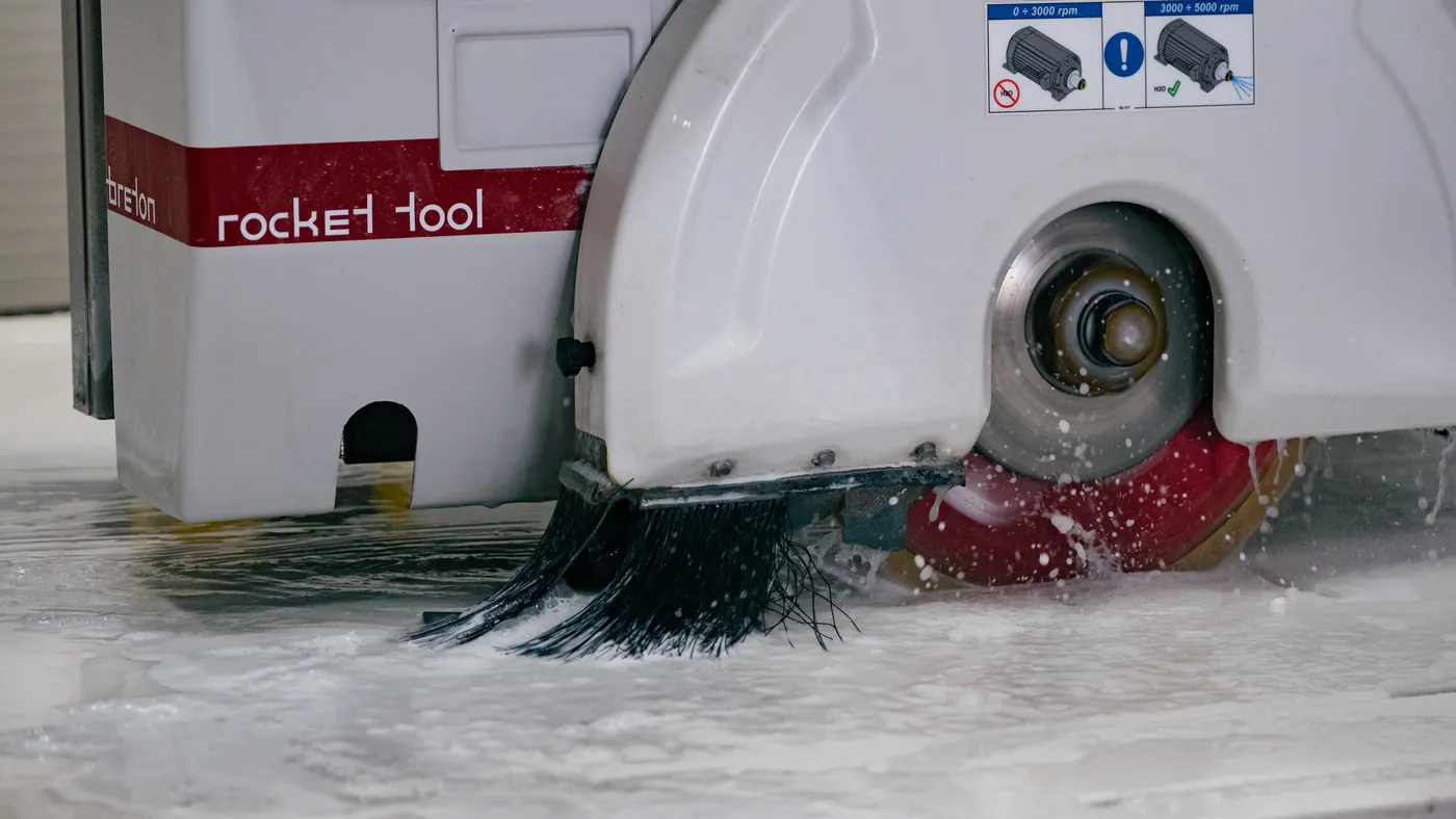 Diamond blade cutting a slab under water spray on our Breton machine